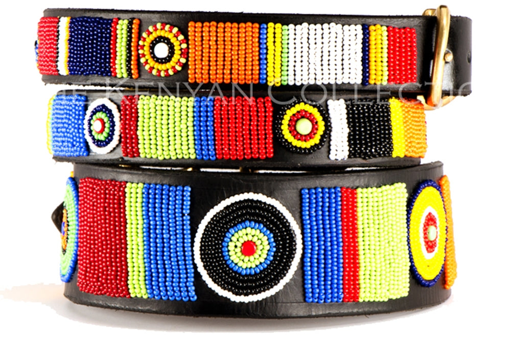 Beaded belts from Southlake Paws featuring vibrant patterns in red, blue, yellow, green, and black on a black background.