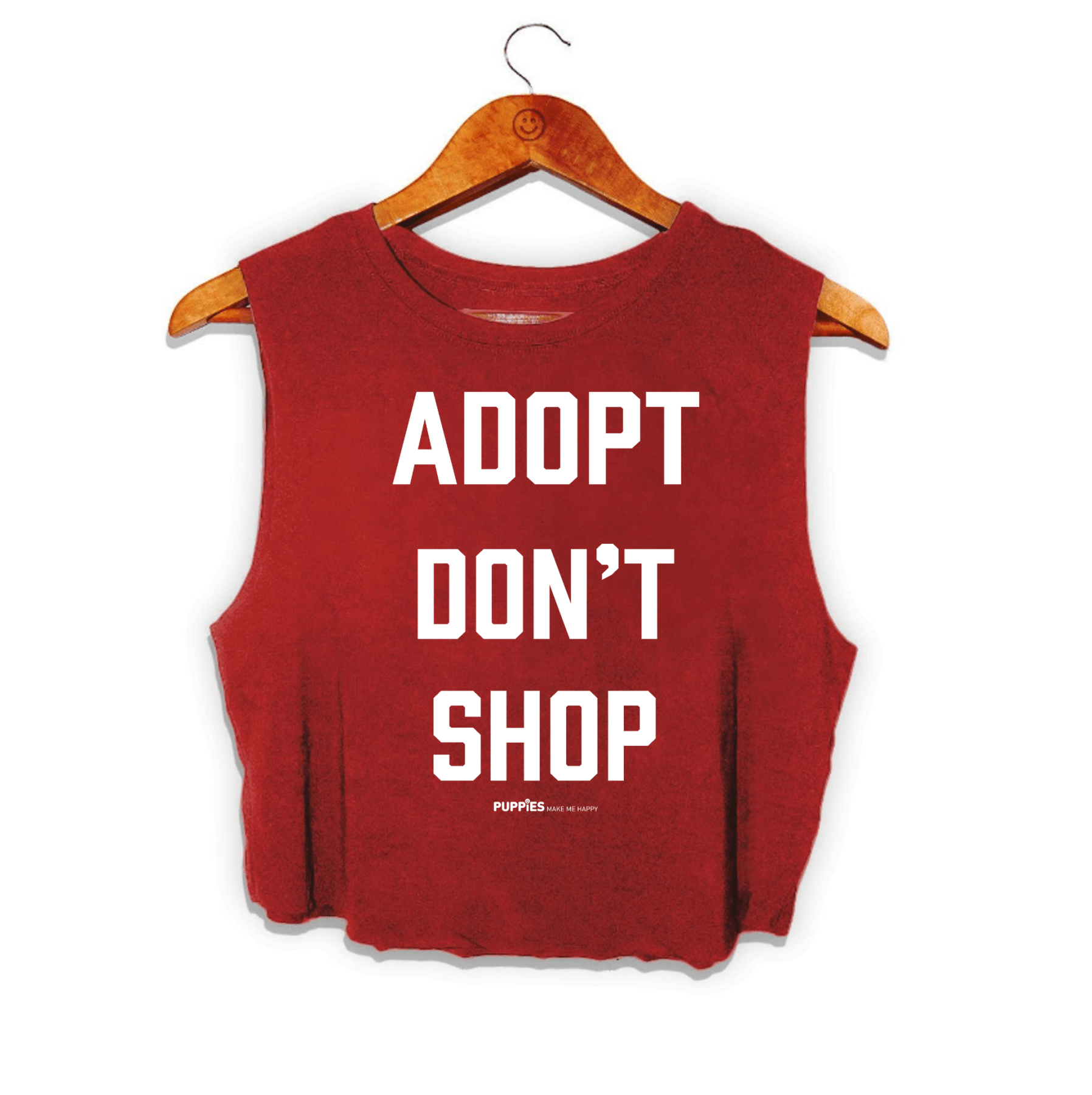 Red crop top with "ADOPT DON'T SHOP" printed in bold white letters, hanging on a wooden hanger. Ideal gift for dog lovers.
