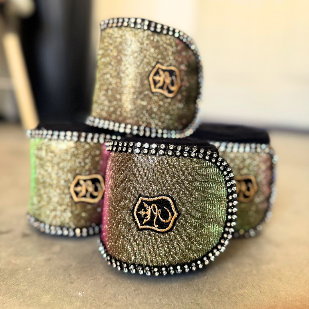 Southlake Paws Astris Polo Wraps in shimmering gold and green with black trim and rhinestone detailing, stacked together.