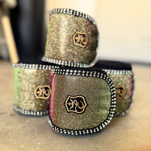 Southlake Paws Astris Polo Wraps in shimmering gold and green with black trim and rhinestone detailing, stacked together.
