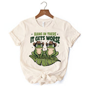 Hang In There It Gets Worse T-Shirt, White and Natural Funny Frog Tee with Dark Millennial Humor 