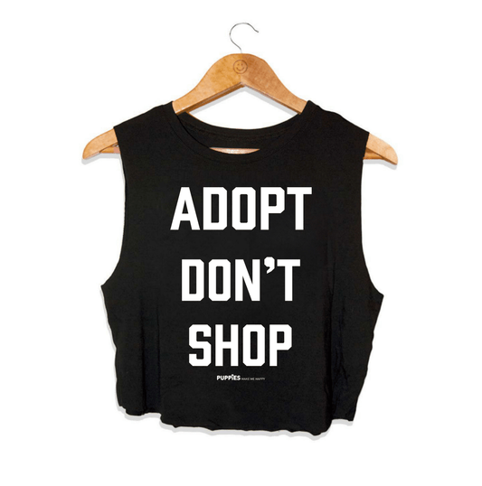 Black crop top with the text "ADOPT DON'T SHOP" in bold white letters, designed for dog lovers. Made in the USA.