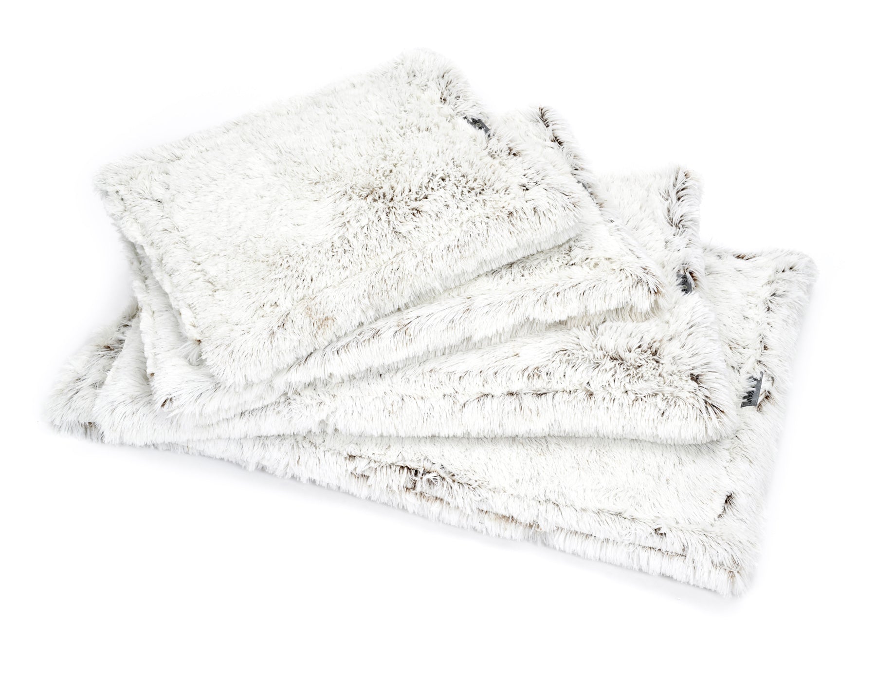 Southlake Paws Arctic Shag Cozy Mat, featuring soft, fluffy white fabric with a shaggy texture, stacked in a neat arrangement