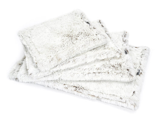 Southlake Paws Arctic Shag Cozy Mat, featuring soft, fluffy white fabric with a shaggy texture, stacked in a neat arrangement