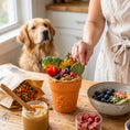 Load image into Gallery viewer, Large Flower Pot eCup Dog Treat Dispenser by Southlake Paws, filled with treats and vegetables, with a dog in the background.
