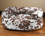 Bowsers Pet Products premium orthopedic donut dog bed with brown and white cow print cushion