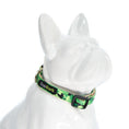 Load image into Gallery viewer, EcoBark Camo Bow Tie Dog Collar featuring a camouflage print, displayed on a white dog figurine.
