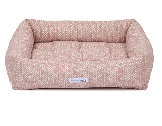 Southlake Paws SlumberJax Dottie Blush Dozer pet bed in a soft blush color with a textured pattern and cushioned sides.