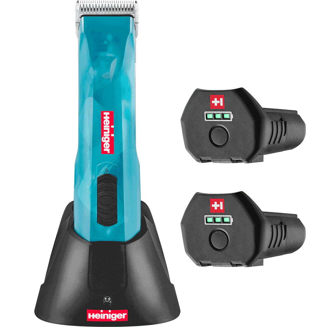 Heiniger Opal Cordless Clipper in teal with two batteries and charging dock, featuring battery level indicators.