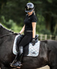 Load image into Gallery viewer, Holographic Saddle Pad by Southlake Paws on a black horse, rider in black attire, showcasing a shimmering design.
