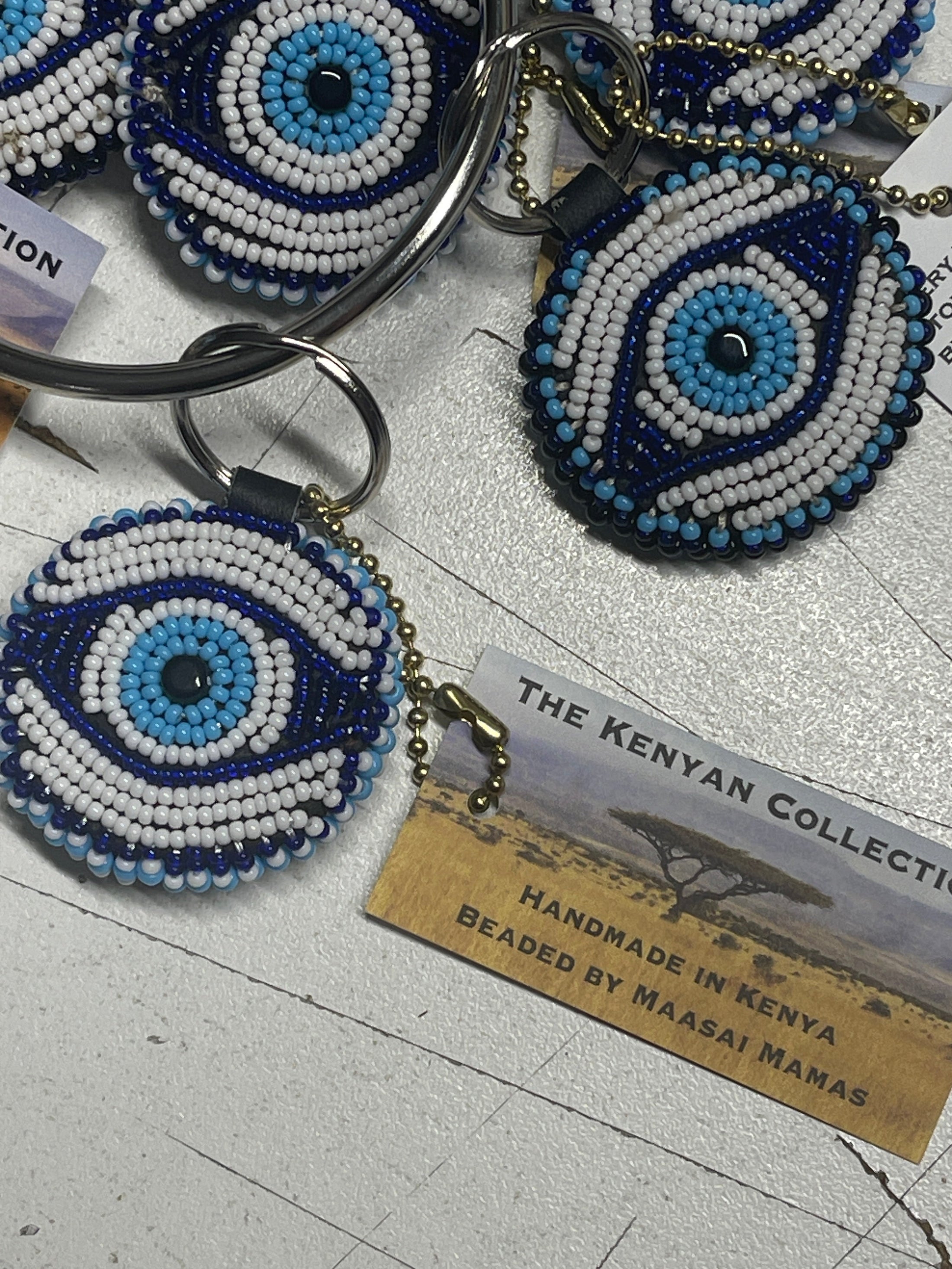 Colorful TKC Beaded Keychain by Southlake Paws, featuring an eye design with blue and white beads, attached to a keyring.