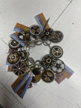 Load image into Gallery viewer, Beaded keychain from Southlake Paws featuring intricate designs in black, white, and gold, attached to metal keyrings.
