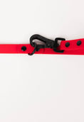 Load image into Gallery viewer, Ruby Red Adjustable Leash by The Modern Dog Company featuring a black clip and buttons on a smooth red strap.
