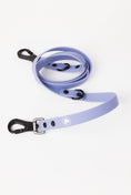 Load image into Gallery viewer, Lavender purple adjustable dog leash with black clips and buckle, featuring a logo on the strap. Ideal for pet owners.
