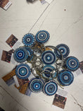Load image into Gallery viewer, Beaded keychains in blue tones with circular designs, arranged on a table with promotional cards. Southlake Paws TKC Beaded K
