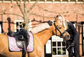 Load image into Gallery viewer, Lavender Saddle Pad by Southlake Paws on a horse, with a smiling rider embracing the horse in a sunny outdoor setting.
