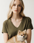 Load image into Gallery viewer, Paw Love Silver Chain Necklace by Southlake Paws worn by a woman holding a fluffy Pomeranian puppy.
