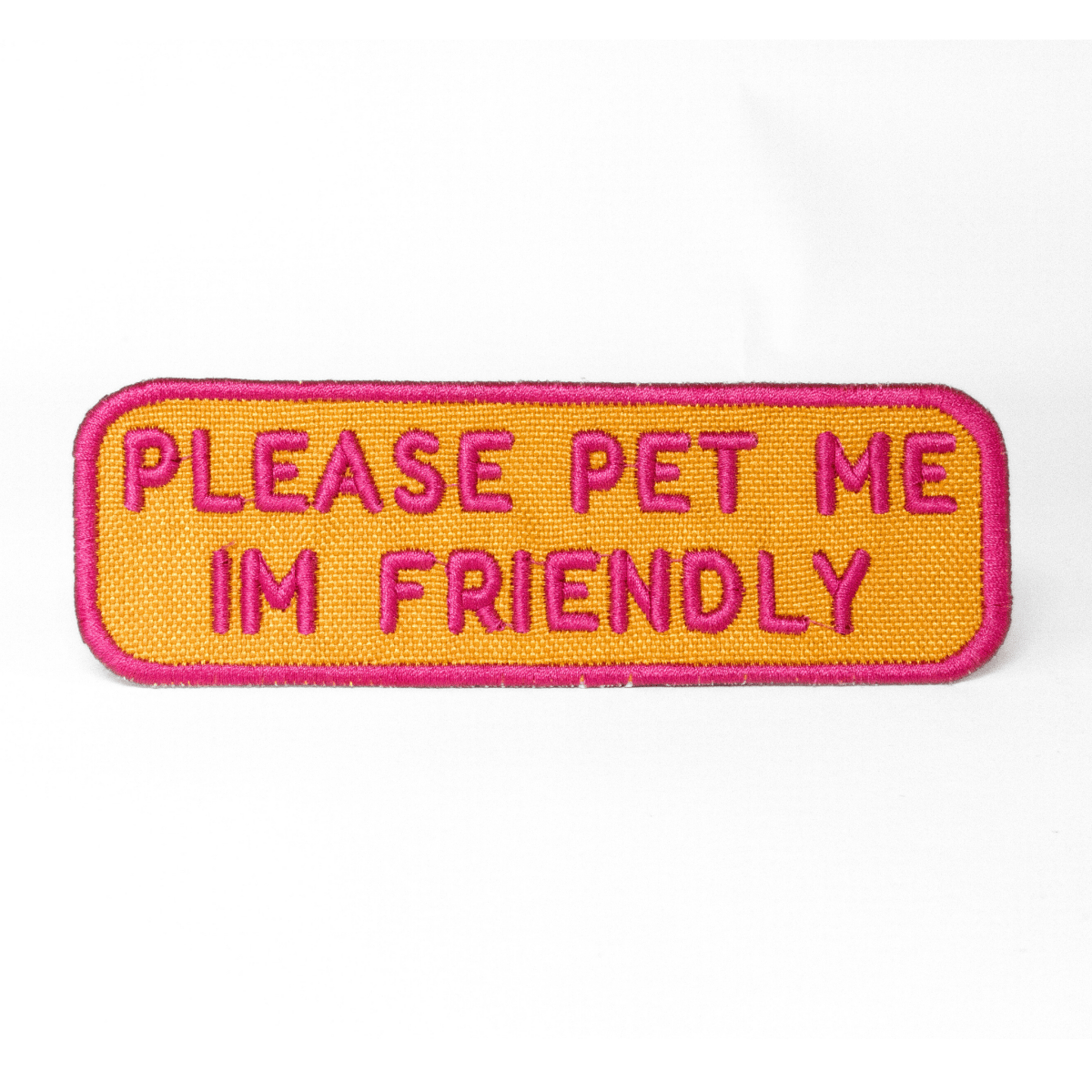 Southlake Paws Please Pet Me Patch features a bright orange background with pink embroidered text stating "PLEASE PET ME I'M 