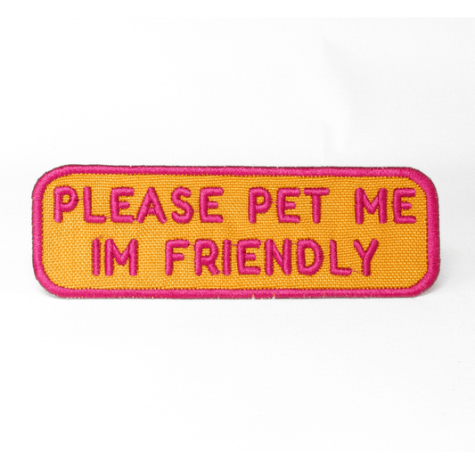 Southlake Paws Please Pet Me Patch features a bright orange background with pink embroidered text stating "PLEASE PET ME I'M 